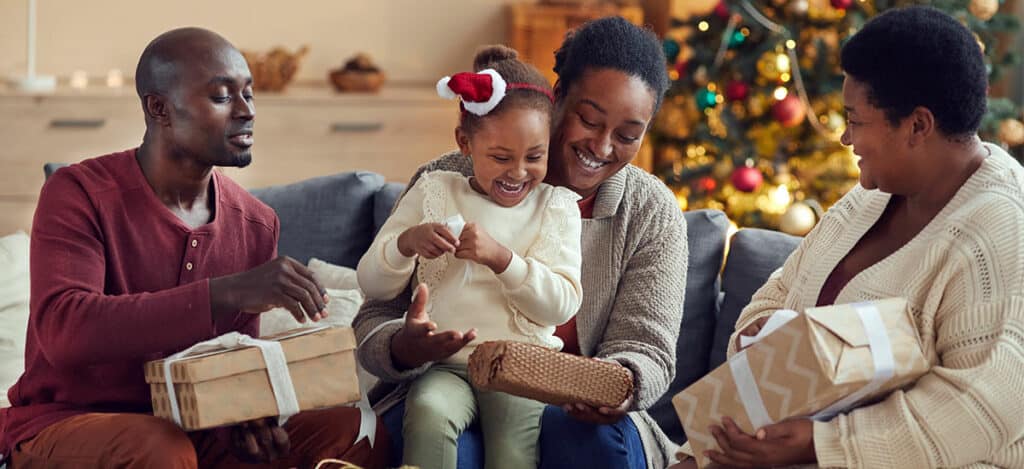 Festive family opening presents during holidays while protecting their hearing health